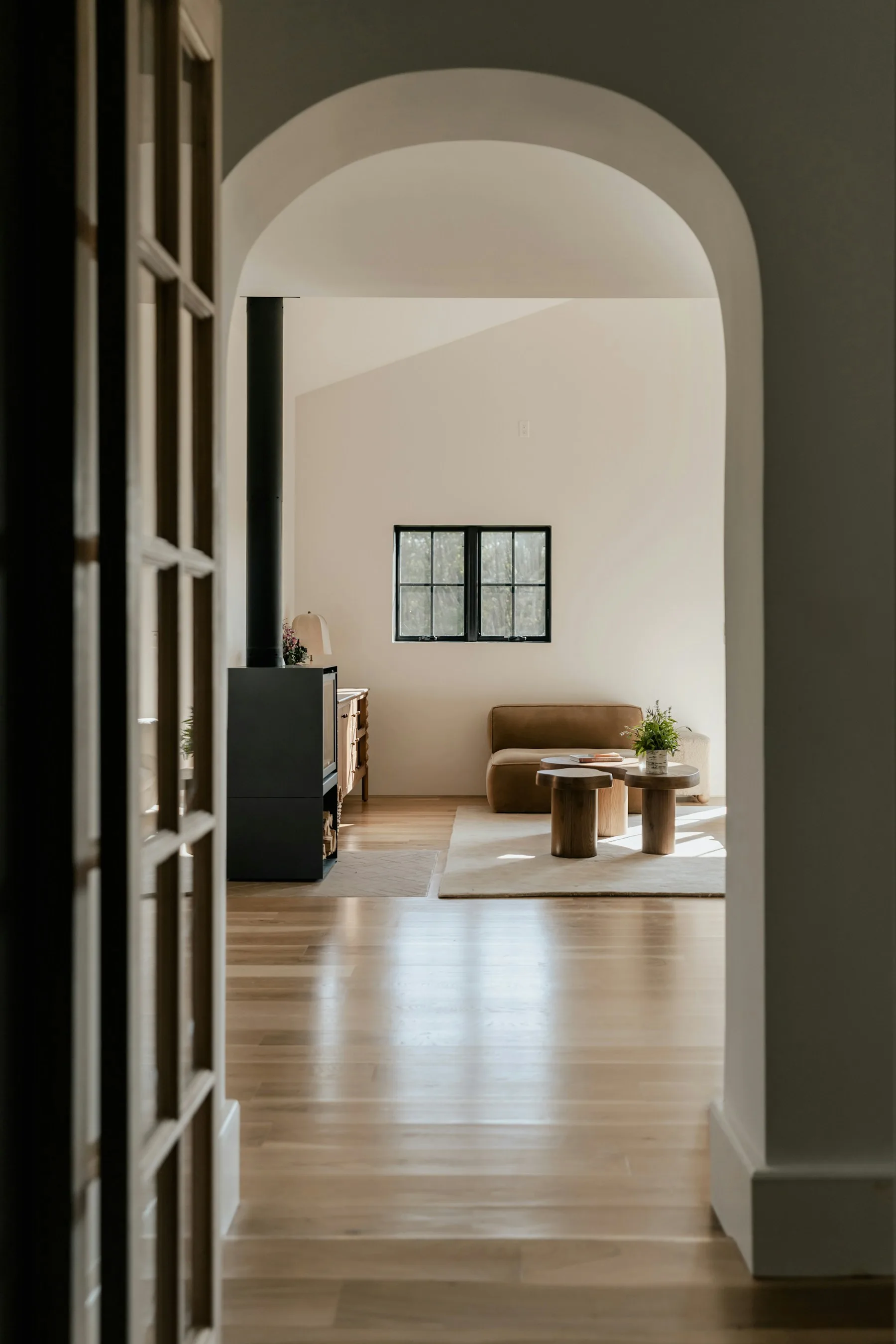 Warm, light-filled hallway opening into a living space